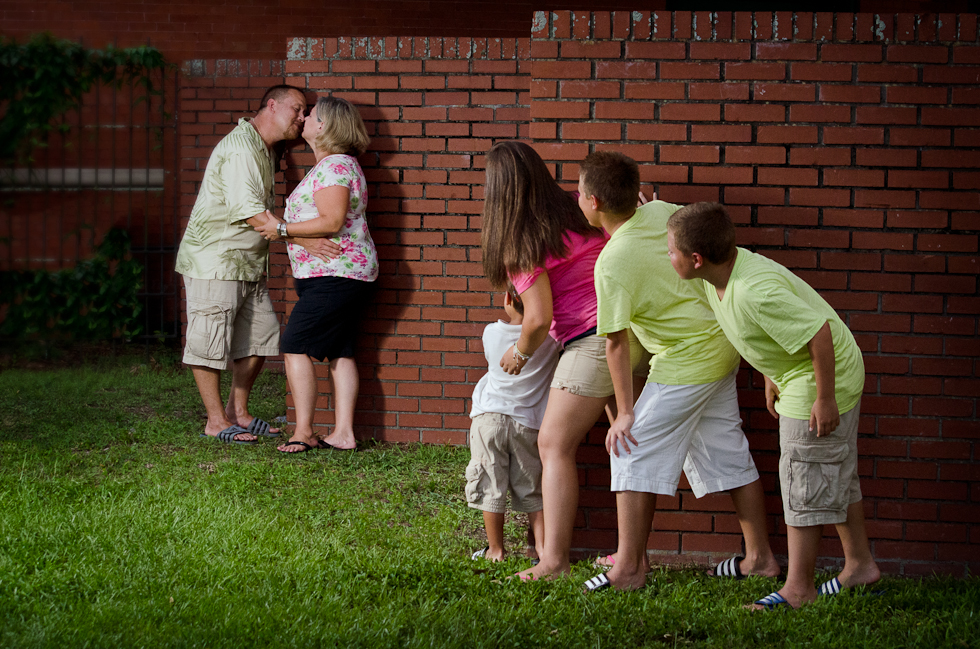Family_Photographer_Plant_City (18) family portrait, mom and dad kiss as kids look on