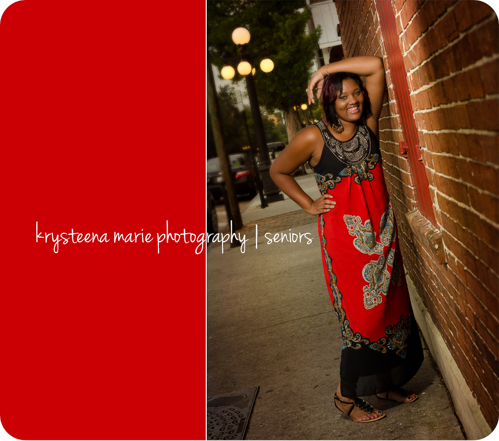 high school senior portraits girl in red dress against brick wall